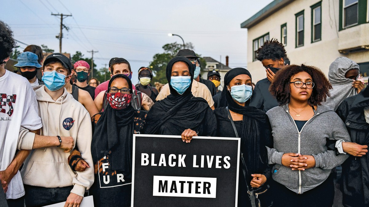 TENSIONS BOIL On June 1, a week after George Floyd’s death in police custody, protesters gather at a makeshift memorial for him in Minneapolis. Protests and riots broke out across the country in response to how Floyd and other black men are treated by the police and the lack of swift arrests and charges for all four former officers involved in his killing.