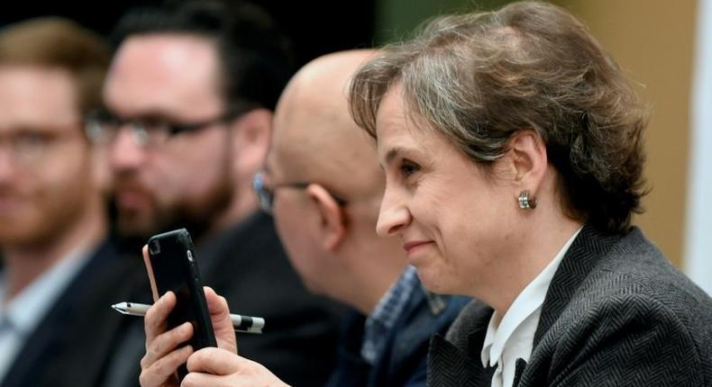 Mexican journalist Carmen Aristegui holds her mobile phone during a press conference in Mexico City, on June 19, 2017