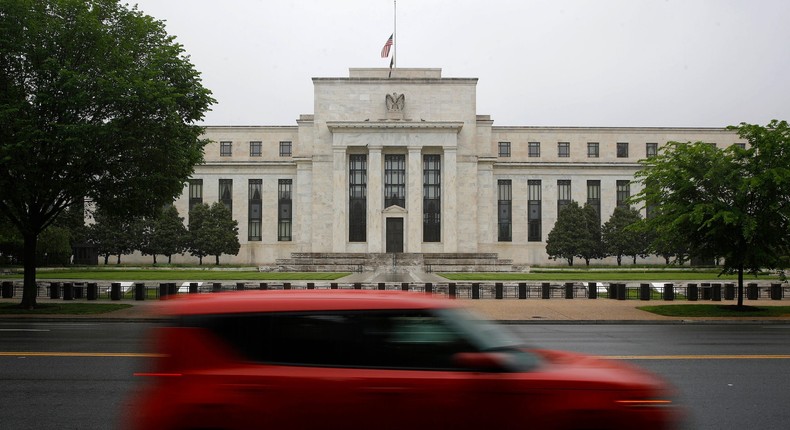 In this May 22, 2020, file photo, a car drives past the Federal Reserve building in Washington.