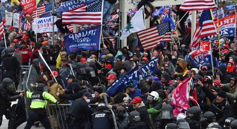 Trump supporters clash with police and security forces as they push barricades to storm the US Capitol in Washington D.C on January 6, 2021.
