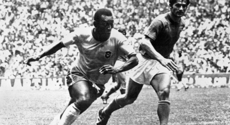 Brazilian midfielder Pele (L), today considered the greatest footballer ever by many, dribbles past Italian defender Tarcisio Burgnich during the 1970 World Cup final in Mexico City