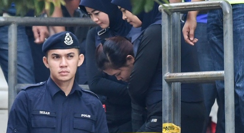 Heavy security for the accused Siti Aisyah (C) and Doan Thi Huong (not pictured) at the pre-trial hearing in Malaysia into the murder of Kim Jong-Nam