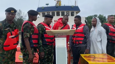 Picture showing the Commanding Officer handing over MV TIS IV vessel in Brass. [NAN]