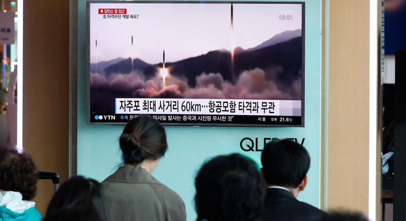 People watch a TV broadcasting of a news report on North Korea's missile launch, at a railway station in Seoul, South Korea.