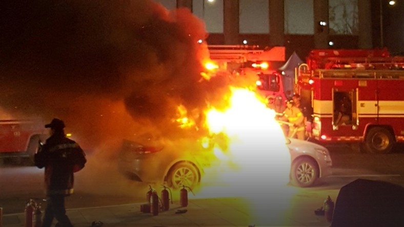 Photo by eyewitness Lee Sang-ho shows a burning taxi as a driver commits suicide near the US embassy in Seoul