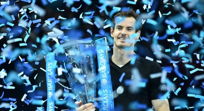 Britain's Andy Murray celebrates with the trophy after winning the men's singles final on the eighth and final day of the ATP World Tour Finals tennis tournament in London November 20, 2016