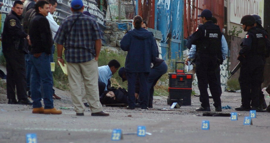 Forensic officers and policemen work in the area where 15 men were killed in one of the deadliest shootouts in Mexico's then three-year-old narco-war, Tijuana, April 26, 2008.