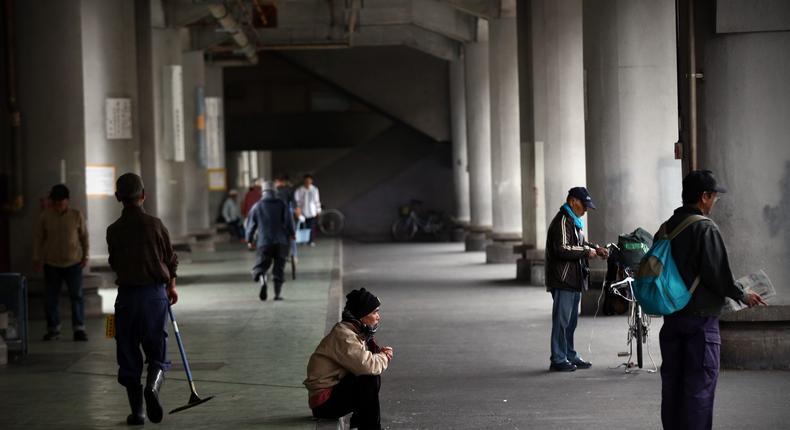 Homeless men wait around for the offer of work in the slum area of Kamagasaki on April 23, 2016 in Osaka, Japan.Carl Court/Getty Images