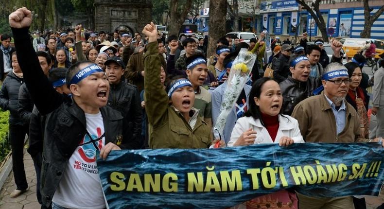 Activists chant anti-China slogans during a rally in Hanoi, Vietnam, on the anniversary of a 1988 battle in the Spratly Islands