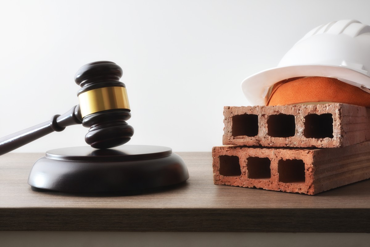 Judgment,Concept,Regarding,Construction,With,Judge's,Gavel,And,Bricks,With