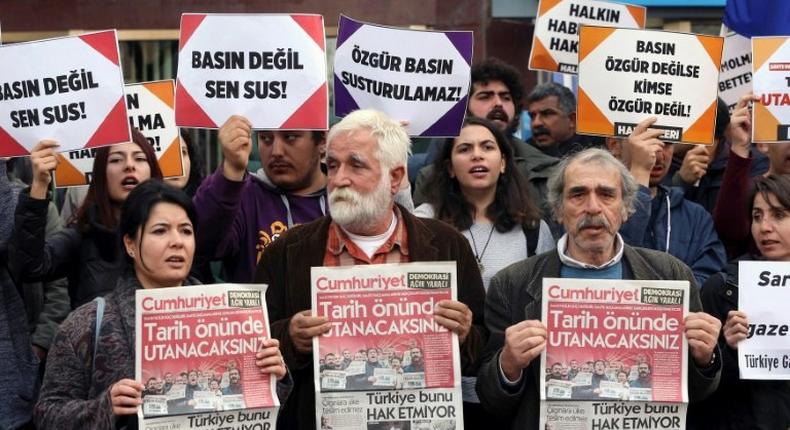 Protesters hold copies of Turkish daily newspaper Cumhuriyet during a demonstration outside the newspaper's headquarters in Ankara in November 2016, following the arrest of nine Cumhuriyet staff