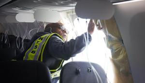 Investigator-in-charge John Lovell examines the area where the plane's door plug had been.National Transportation Safety Board