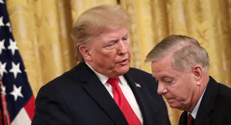 Former President Donald Trump speaks to Sen. Lindsey Graham (R-SC) during an event in the East Room of the White House on November 6, 2019.
