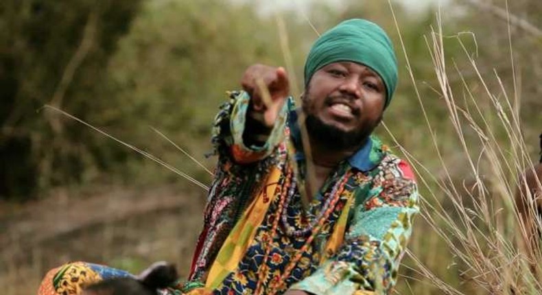 Blakk Rasta dressed in an African print