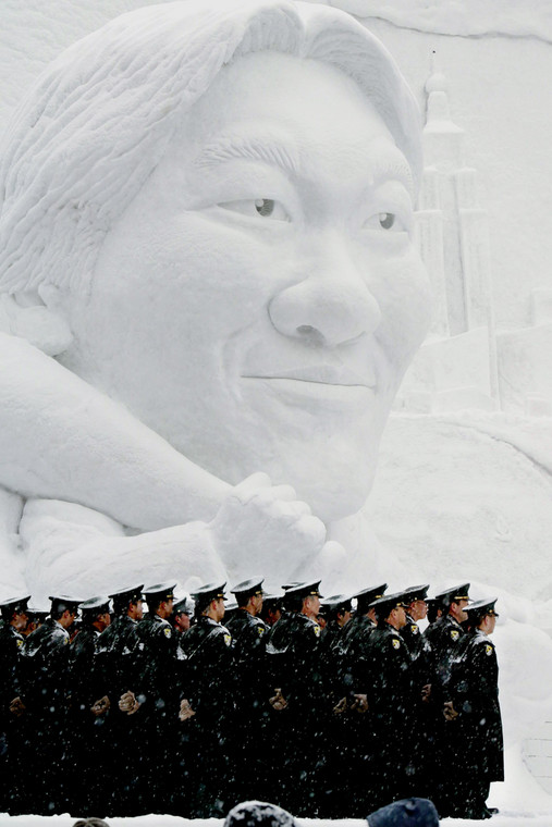 Japońscy żołnierze przed śnieżną rzeźbą zanego w Japonii zawodnika baseballu Hideki Matsui. Festiwal Śniegu w Sapporo w lutym 2004 r.