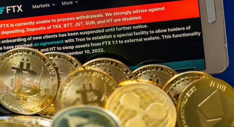 FTX logo with crypto coins with 100 Dollar bill are displayed for illustration. FTX has filed for bankruptcy in the US, seeking court protection as it looks for a way to return money to users.Jonathan Raa/NurPhoto via Getty Images