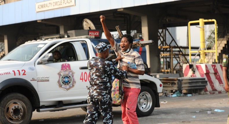 Police Task Force arresting a peaceful protester at the Lekki Toll Gate Plaza