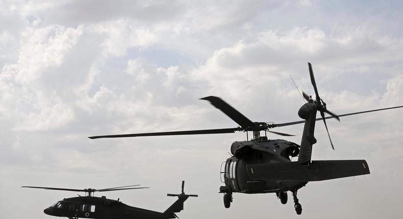 A view of UH-60 Black Hawk helicopters carrying U.S. and Afghan trainees take off at Kandahar Air Field, in Afghanistan, Monday, March 19, 2018.