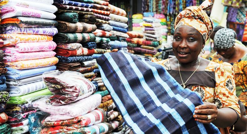 An Africa woman selling fabrics in a market