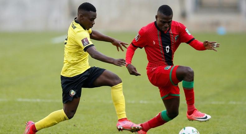 Midfielders Luis Miquissone (L) of Mozambique and John Banda (R) of Malawi contest possession during a World Cup qualifier in Soweto on Tuesday Creator: PHILL MAGAKOE