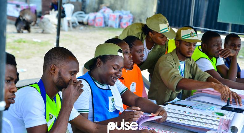 Members of the NYSC as INEC ad-hoc staff at a polling unit in Victoria Island/Illustration (Pulse)