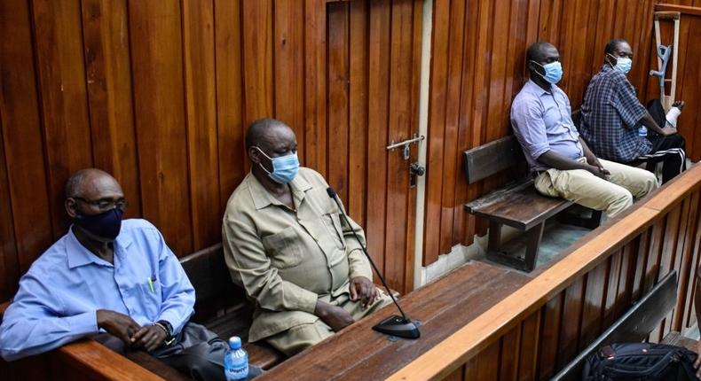 Kenyan police officers, Naftali Chege (L), Charles Munyiri Wagombe (2nd-L), Ismael Baraka Bulima (2nd-R) and John Pamba (R), sit in the dock at the Mombasa Law Court in Mombasa, on November 15, 2021. (Photo by DIHOFF MUKOTO/AFP via Getty Images)