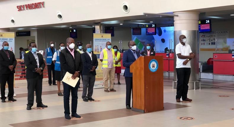 Health CS Mutahi Kagwe, Transport CS James Macharia and Ministry of Health Director General Patrick Amoth during a Covid-19 briefing from JKIA 