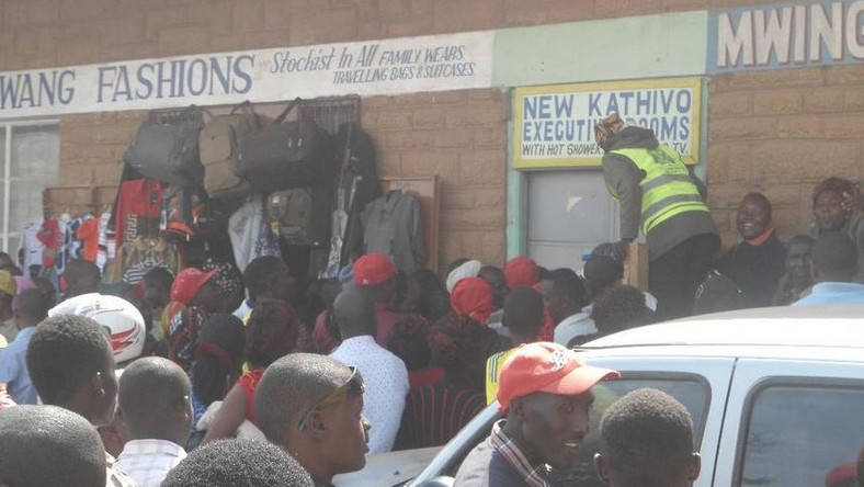 File image of a crowd outside a lodging where a man was caught engaging in sexual acts with a married woman