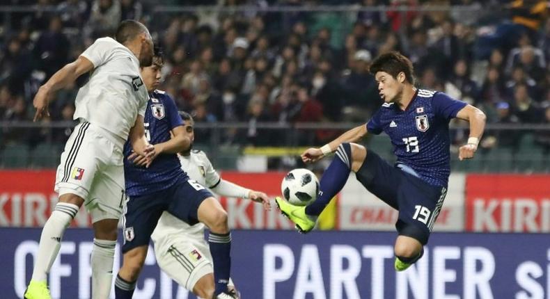 Japan's defender Hiroki Sakai (R) scored a 39-minute opener, his first goal for the national team on his 49th international