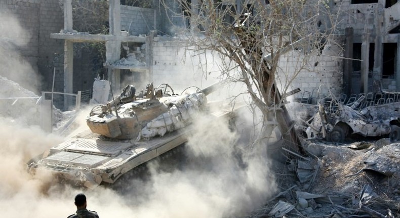 A pro-government tank is driven across rubble in Qabun district, on the outskirts of the Syrian capital Damascus, on May 13, 2017