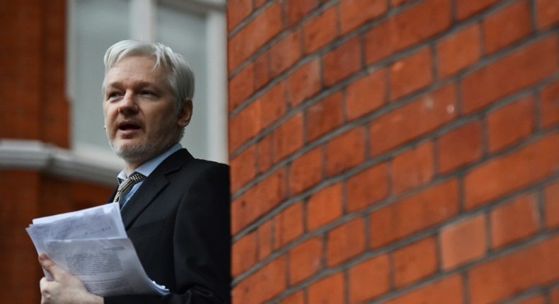 WikiLeaks founder Julian Assange addressing the media and holding a printed report of the judgement of the UN's Working Group on Arbitrary Detention on his case from the balcony of the Ecuadorian Embassy in central London on February 5, 2016