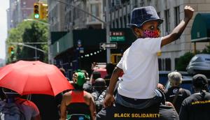 A man carries a child on his shoulders as they march near Central Park during a 2020 Juneteenth celebration.Frank Franklin II/Associated Press