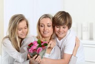 Children offering bunch of flowers on mother's 