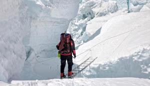 Navigating the Khumbu Icefall involves crossing ladders laid over crevasses that can be up to hundreds of feet deep.Jason Maehl/Getty Images