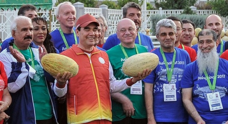 Turkmen President Gurbanguly Berdymukhamedov, surrounded by officials and participants of the upcoming 2017 Asian Indoor and Martial Arts Games, poses with melons during Melon Day celebrations in Ashgabat