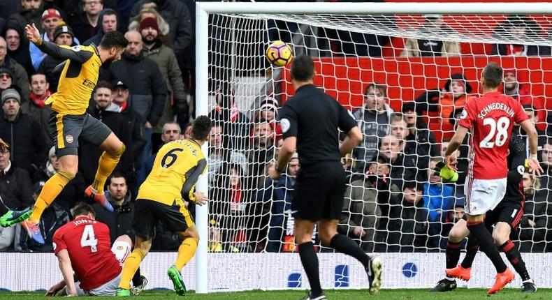 Arsenal's French striker Olivier Giroud (left) scores his team's first goal during the English Premier League match against Manchester United at Old Trafford in Manchester on November 19, 2016