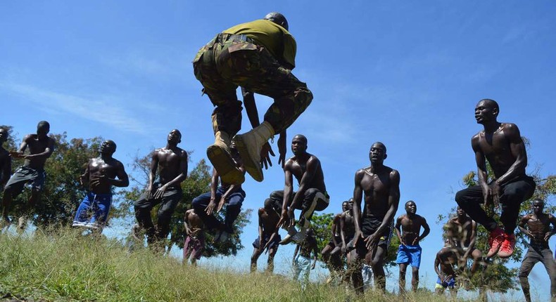 A KDF official takes recruits through a drill during tryouts