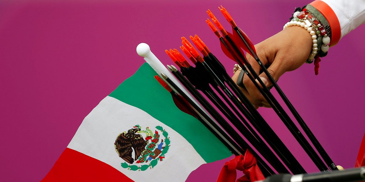 Mexico's Aida Roman takes an arrow from her quiver, in which a Mexican national flag can be seen, during the women's archery individual round of 8 eliminations at the London 2012 Olympic Games at the Lord's Cricket Ground August 2, 2012.