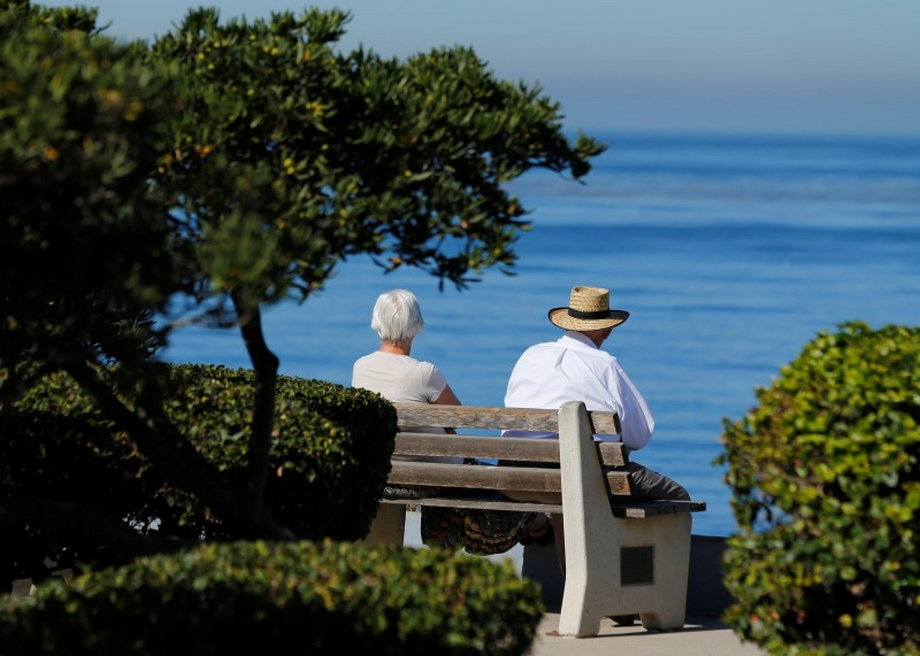 An elderly couple on a park bench in La Jolla, California.