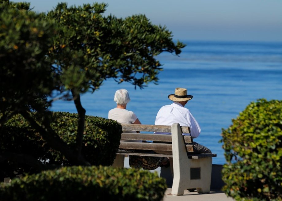 An elderly couple on a park bench in La Jolla, California.