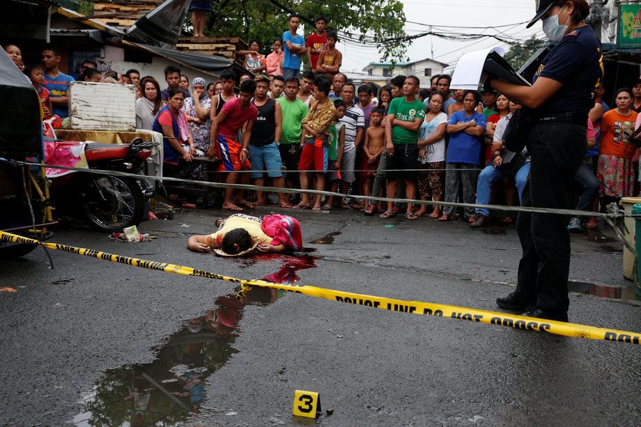 Nora Acielo, 47, lies dead after she was gunned down by unidentified men while she was escorting her two children to school in Manila, Philippines, December 8, 2016. Police said Acielo was among more than 30 people slain over the last three days in drugs-related killings.