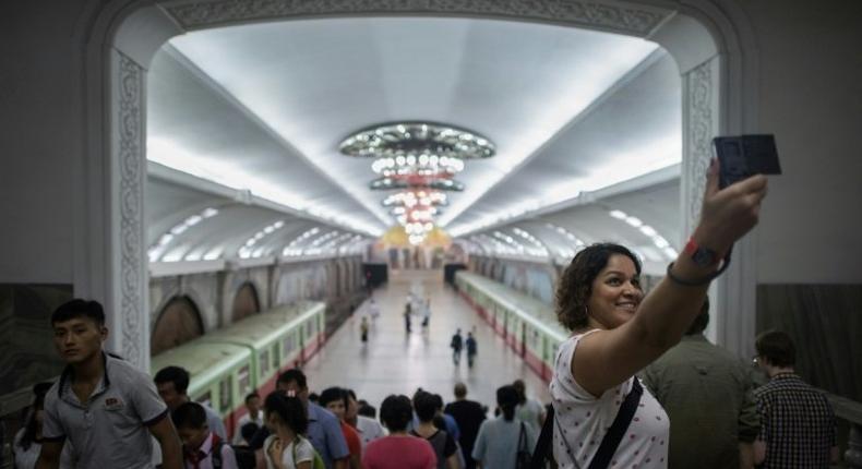 A tourist takes a selfie during a visit to a subway station in Pyongyang -- around 5,000 Western travellers visit the North each year, tour companies say