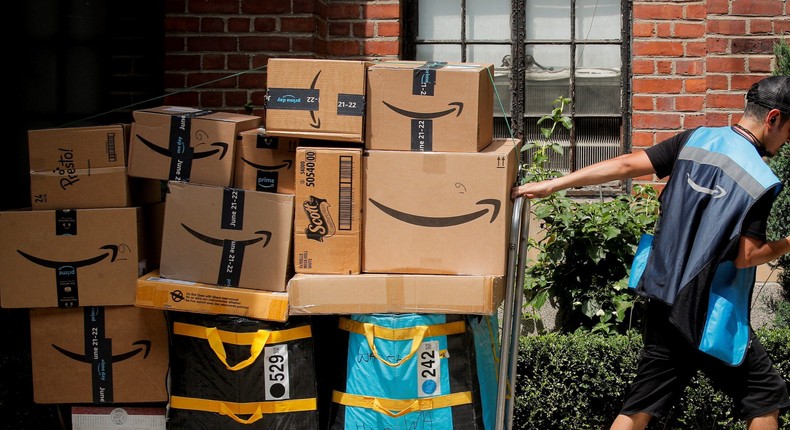 An Amazon delivery worker pulls a delivery cart full of packages.Brendan McDermid/Reuters