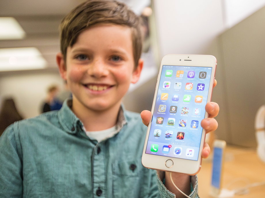 Levi, 10, shows off the iPhone 6S Plus in rose gold at an Apple Store in Sydney, Australia, on September 25, 2015.