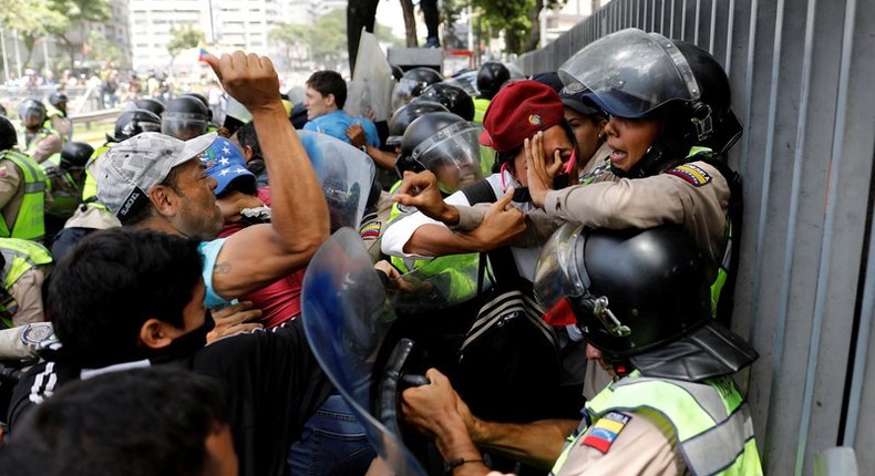 Demonstrators scuffle with security forces during an opposition rally in Caracas, Venezuela.