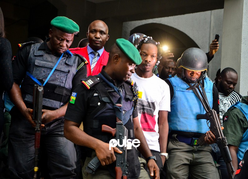 Naira Marley being escorted to the court during his trial in 2019 [PULSE]