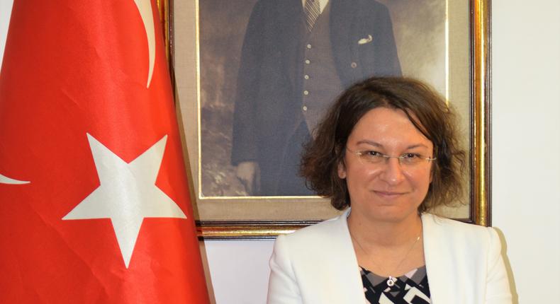 Former Turkish Ambassador to Kenya, Her Excellency Ambassador, Deniz Eke, standing next to the portrait of Turkish flag and below Turkish founder Mustafa Kemal Atatürk (George Tubei)