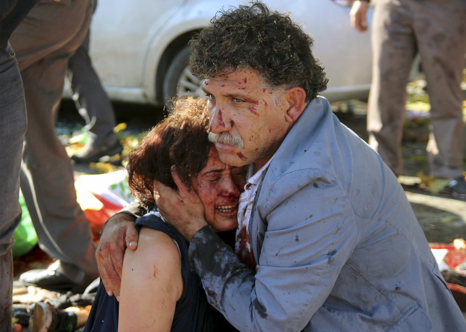 An injured man hugs an injured woman after an explosion during a peace march in Ankara, Turkey, October 10, 2015.