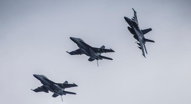 F/A-18 Super Hornets fly in formation near aircraft carrier USS Carl Vinson during Rim of the Pacific Exercise in 2018.US Navy photo by Mass Communication Specialist 3rd Class Dylan M. Kinee/Released