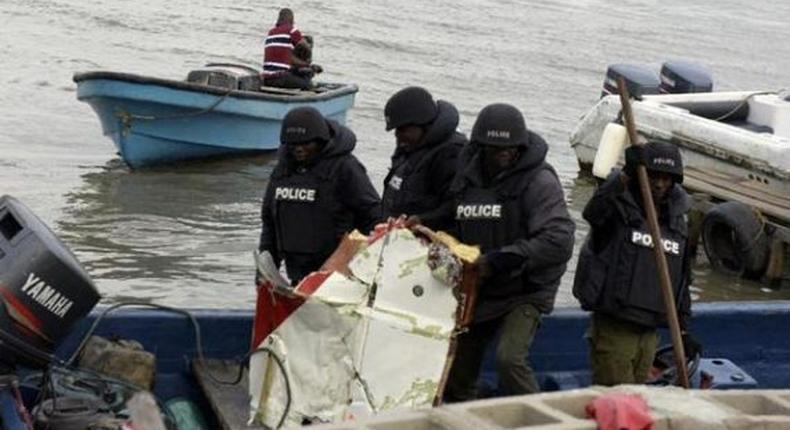 Workers at the scene of a helicopter crash in Oworonshoki, Lagos